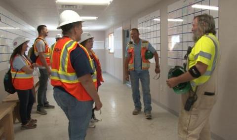 Teachers speak with construction staff during the 2018 Teacher Externship